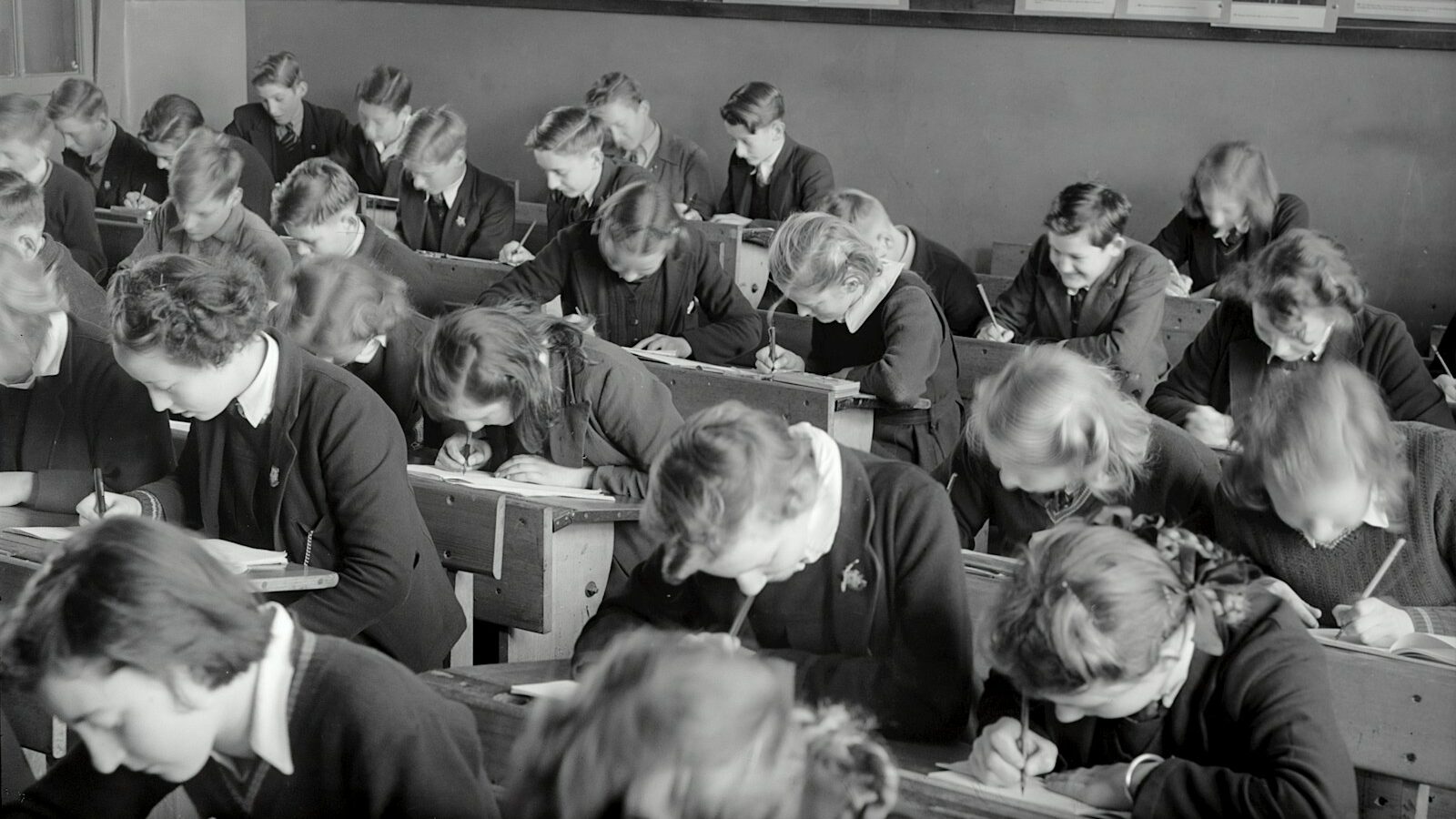 grayscale photo of people sitting on chair